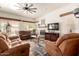 Open concept living area with oversized fan, sliding glass door, fireplace and comfortable seating at 5993 W Topeka Dr, Glendale, AZ 85308