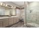 Main bathroom boasts a glass shower, double sinks, and wood accents at 5993 W Topeka Dr, Glendale, AZ 85308