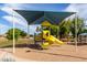 Fun community playground with a slide, climbing structure, and shaded seating area at 5993 W Topeka Dr, Glendale, AZ 85308
