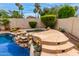 Inviting backyard pool and spa area with rock features and lush landscaping at 5993 W Topeka Dr, Glendale, AZ 85308