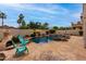 Inviting backyard featuring a pool, waterfall feature, lush greenery, and comfortable lounge chairs at 5993 W Topeka Dr, Glendale, AZ 85308