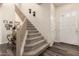 Entryway featuring beautiful hardwood floors, carpeted stairs, and stylish sconces at 5993 W Topeka Dr, Glendale, AZ 85308