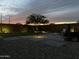 Backyard features pavers, gravel, and grass plus outdoor lighting and planters at 6338 W Raymond St, Phoenix, AZ 85043