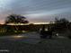 This backyard features pavers, gravel, a patch of grass and a outdoor furniture set at 6338 W Raymond St, Phoenix, AZ 85043