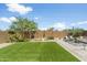 Fully fenced backyard with lush green grass and landscaped features, perfect for relaxation at 6338 W Raymond St, Phoenix, AZ 85043