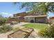 Landscaped backyard with lush greenery, paved patio, and cozy seating area with privacy at 6338 W Raymond St, Phoenix, AZ 85043