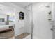 Shower and bedroom shows tiled shower, modern fixtures, and bright lighting at 6338 W Raymond St, Phoenix, AZ 85043