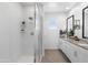 Modern bathroom with a glass-enclosed shower and updated fixtures at 6338 W Raymond St, Phoenix, AZ 85043