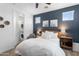 Comfortable bedroom featuring a queen-size bed, in-unit laundry, and natural lighting at 6338 W Raymond St, Phoenix, AZ 85043