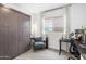 Cozy bedroom with a comfortable chair and a built-in wardrobe for ample storage at 6338 W Raymond St, Phoenix, AZ 85043