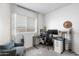 Well-lit room features a work area with a sleek desk, providing a functional workspace at 6338 W Raymond St, Phoenix, AZ 85043