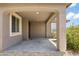 Covered entryway with stone landscaping, neutral paint, and outdoor lighting at 6338 W Raymond St, Phoenix, AZ 85043