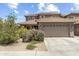 Two-story home with a large, attached garage, tile roof, and low-maintenance landscaping at 6338 W Raymond St, Phoenix, AZ 85043