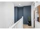 Upstairs hallway with a dark accent wall and modern decor at 6338 W Raymond St, Phoenix, AZ 85043