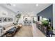 Open-concept living room with modern decor and adjacent kitchen space at 6338 W Raymond St, Phoenix, AZ 85043
