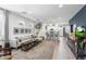 Spacious living room featuring modern decor, large windows, and an open layout at 6338 W Raymond St, Phoenix, AZ 85043