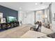Spacious living room featuring a contemporary design with a dark accent wall and stylish furnishings at 6338 W Raymond St, Phoenix, AZ 85043