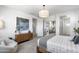Spacious main bedroom featuring a king bed, tasteful decor, and a relaxing seating area at 6338 W Raymond St, Phoenix, AZ 85043