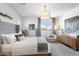 Bright main bedroom with a king bed, stylish decor, and lots of natural light at 6338 W Raymond St, Phoenix, AZ 85043