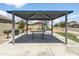 Community picnic area with shaded seating, barbecue grill, and views of the playground at 6338 W Raymond St, Phoenix, AZ 85043