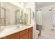 Charming bathroom featuring a white vanity, framed mirror and shower-tub combo at 64 N 63Rd St # 55, Mesa, AZ 85205