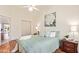 Cozy bedroom with a ceiling fan, light green bedding, and artwork at 64 N 63Rd St # 55, Mesa, AZ 85205