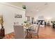 Cozy dining area with a round glass table and views into the spacious living room at 64 N 63Rd St # 55, Mesa, AZ 85205