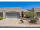 Charming home featuring a two-car garage, desert landscaping, and a quaint front entrance at 64 N 63Rd St # 55, Mesa, AZ 85205