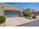 Charming home featuring a two-car garage, desert landscaping, and a quaint front entrance at 64 N 63Rd St # 55, Mesa, AZ 85205