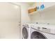 Laundry room with full-size washer and dryer, plus storage space at 64 N 63Rd St # 55, Mesa, AZ 85205