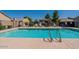 Community pool with lounge chairs and covered seating offers residents a refreshing amenity to enjoy on hot days at 64 N 63Rd St # 55, Mesa, AZ 85205