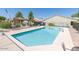 Inviting community swimming pool surrounded by chairs and greenery at 64 N 63Rd St # 55, Mesa, AZ 85205