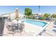 Community pool area featuring clear water, poolside furniture, and a lush landscape at 64 N 63Rd St # 55, Mesa, AZ 85205
