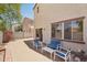 Paver patio backyard featuring outdoor seating area with beige house and vibrant pink flower bush at 7501 S 14Th St, Phoenix, AZ 85042
