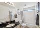 Bathroom featuring a granite countertop, framed mirror and a shower-tub combo at 7501 S 14Th St, Phoenix, AZ 85042