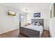 Cozy bedroom featuring a gray upholstered bed, carpet floors, and a wall-mounted television at 7501 S 14Th St, Phoenix, AZ 85042