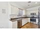 Bright kitchen featuring white cabinetry, granite countertops, and stainless steel appliances, offering modern convenience at 7501 S 14Th St, Phoenix, AZ 85042
