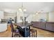 Open-concept living space featuring tile floors, a kitchen, a center island, and a cozy living room area at 7501 S 14Th St, Phoenix, AZ 85042