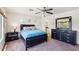 Bright main bedroom featuring a large bed, dark wood furnishings, and access to an ensuite bathroom at 7501 S 14Th St, Phoenix, AZ 85042