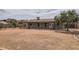 Back exterior showing the covered patio and low maintenance backyard with rock, plants, and block wall at 828 E Le Marche Ave, Phoenix, AZ 85022