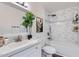 Bright bathroom featuring updated marble tile in shower, stylish art and plant, and a modern sink at 828 E Le Marche Ave, Phoenix, AZ 85022