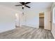Spacious bedroom with closet and bathroom entrances and neutral walls and gray vinyl flooring at 828 E Le Marche Ave, Phoenix, AZ 85022