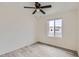 Neutral bedroom features gray vinyl flooring, ceiling fan, and a window providing natural light at 828 E Le Marche Ave, Phoenix, AZ 85022