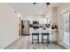 Bright kitchen with island seating, modern appliances, tile backsplash, and gray vinyl flooring at 828 E Le Marche Ave, Phoenix, AZ 85022