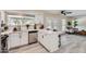 Bright kitchen features white cabinets, stainless steel appliances, quartz countertops, and a view to the living room at 828 E Le Marche Ave, Phoenix, AZ 85022