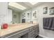 Neutral-toned bathroom featuring a single vanity and a large, well-lit mirror at 8464 N 7Th Ave, Phoenix, AZ 85021