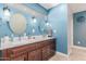 Bathroom featuring double sink vanity, modern fixtures, and a large mirror at 8464 N 7Th Ave, Phoenix, AZ 85021
