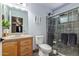 Bathroom featuring vanity with wood cabinets, toilet, and tiled glass shower stall at 8464 N 7Th Ave, Phoenix, AZ 85021