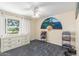 Bright bedroom with ceiling fan, large window, drawers and stacked towels at 8464 N 7Th Ave, Phoenix, AZ 85021