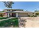 Two-story home features a red door, gray garage door, brick pathway, and manicured lawn at 8464 N 7Th Ave, Phoenix, AZ 85021